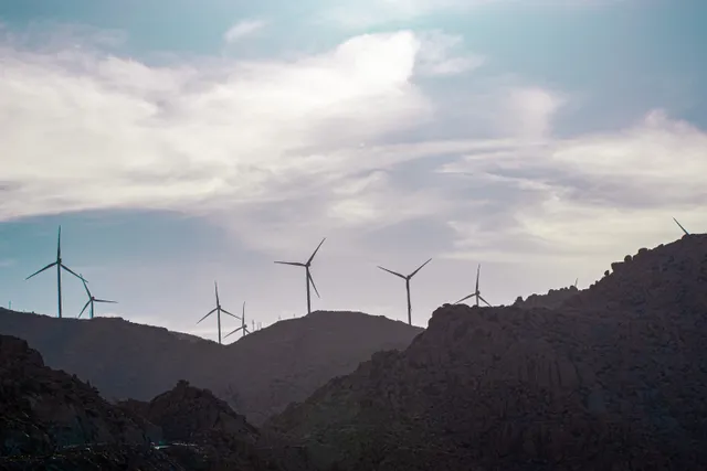Wind turbines across a rocky mountain landscape